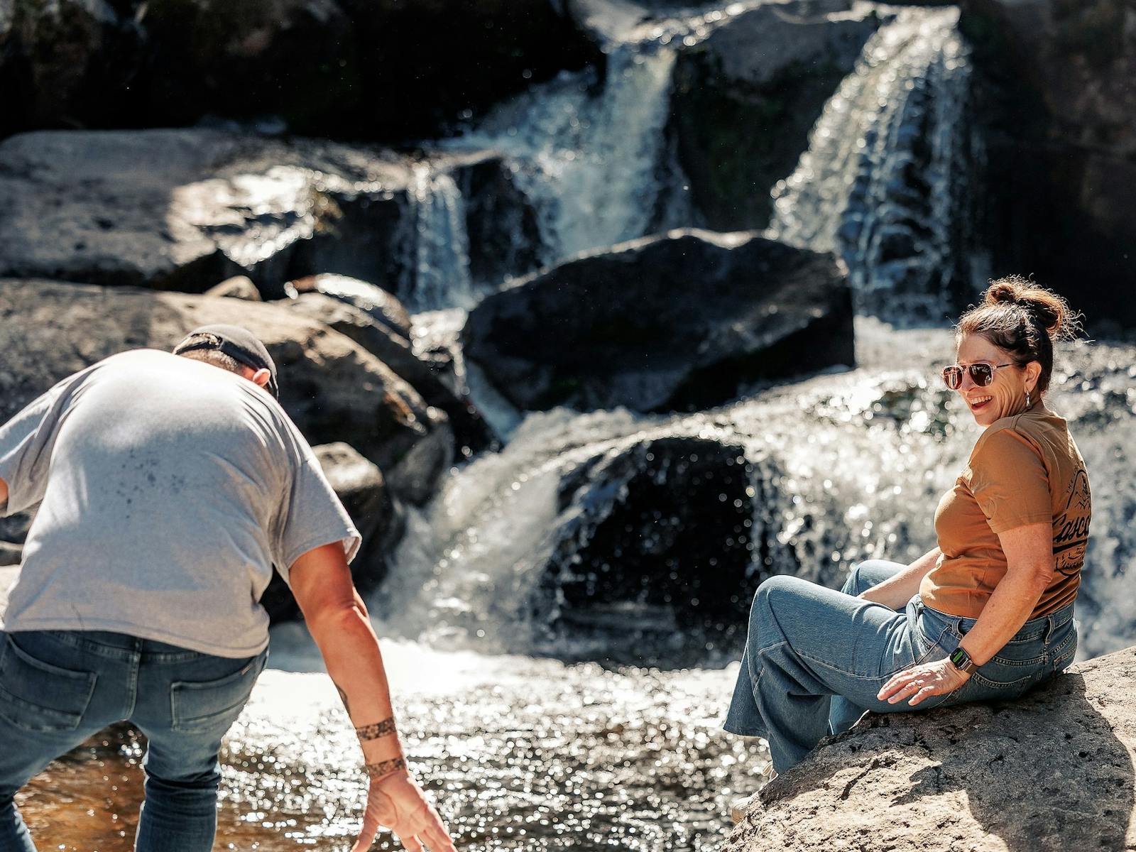 Man and woman sitting on  rocks at Keppel Falls