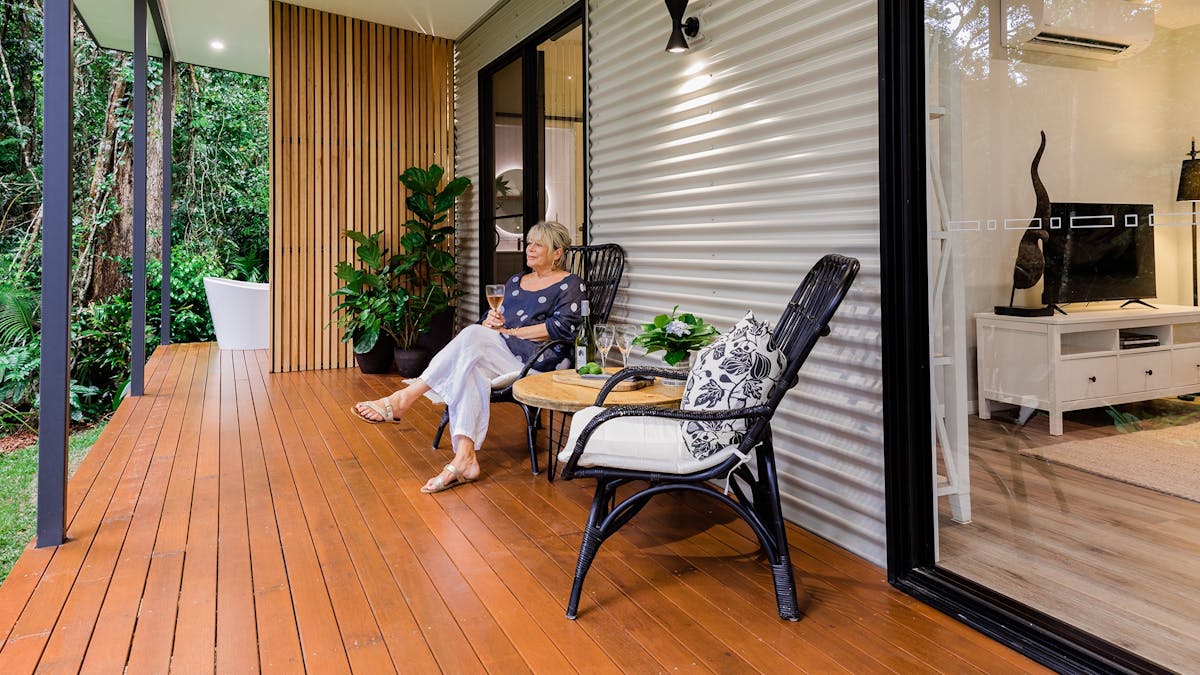 Guest enjoying wine on the deck at Spring Haven Kuranda