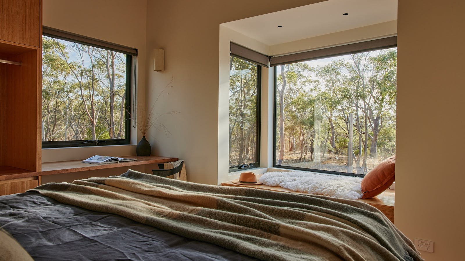 The main bedroom features a king size bed with a bush outlook