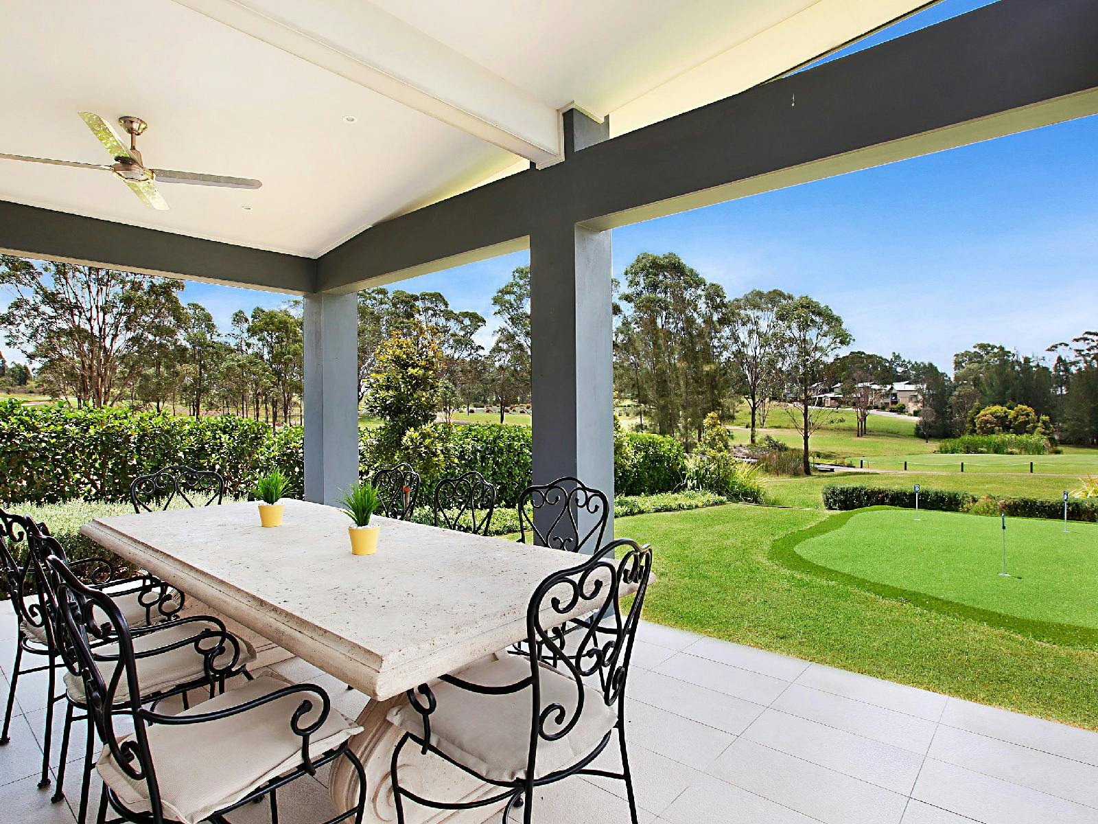 Vista One outdoor dining area with 3 hole putting green