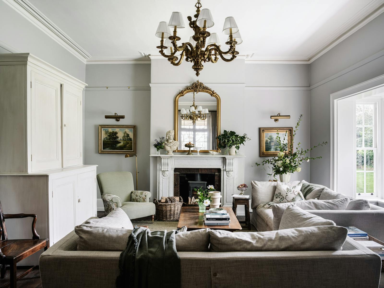 An inviting bright and large lounge room with a double bay window and a wood heater.