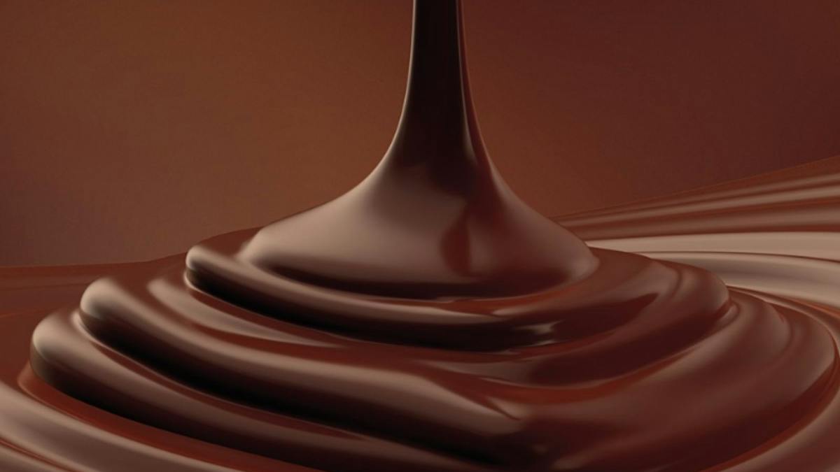 Closeup of melted semi-sweet chocolate, highlights the swirls and texture.