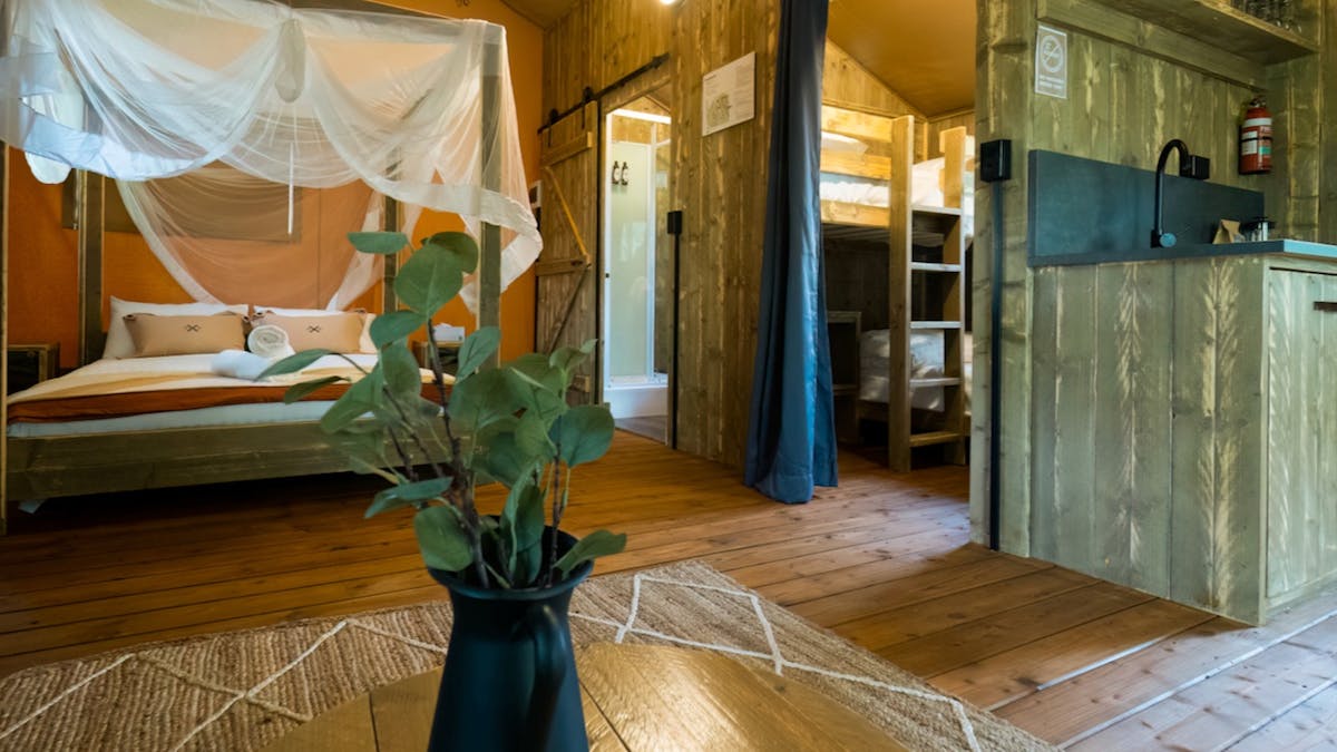 glamping tent interior showing bedroom bathroom kitchen