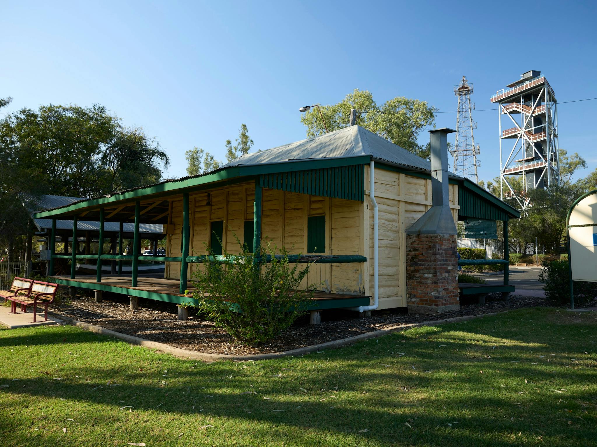 Exterior shot of a white wooden building with green trim Exterior shot of a white wooden building with green trim