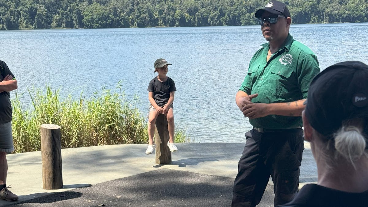Guide talks to group at lake barrine