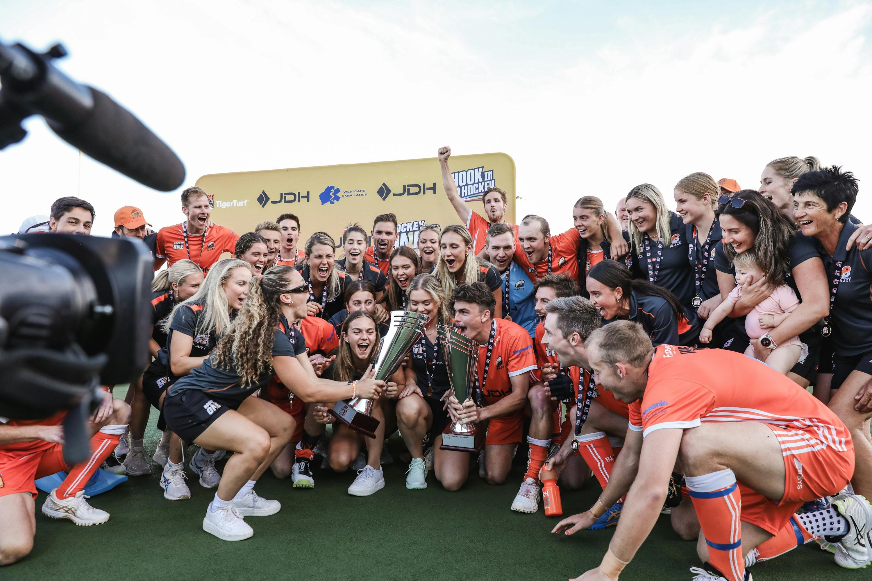an image of Brisbane Blaze players celebrating their 2023 Hockey One championships.