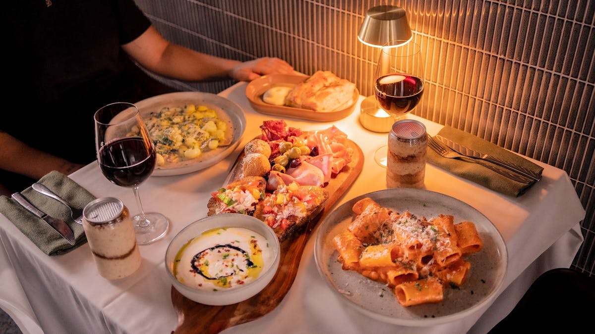 Dining with Italian dishes and low lighting