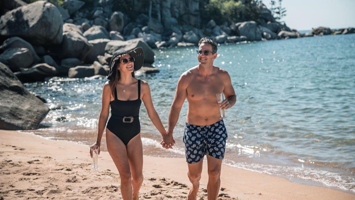Couple walking along a remote beach