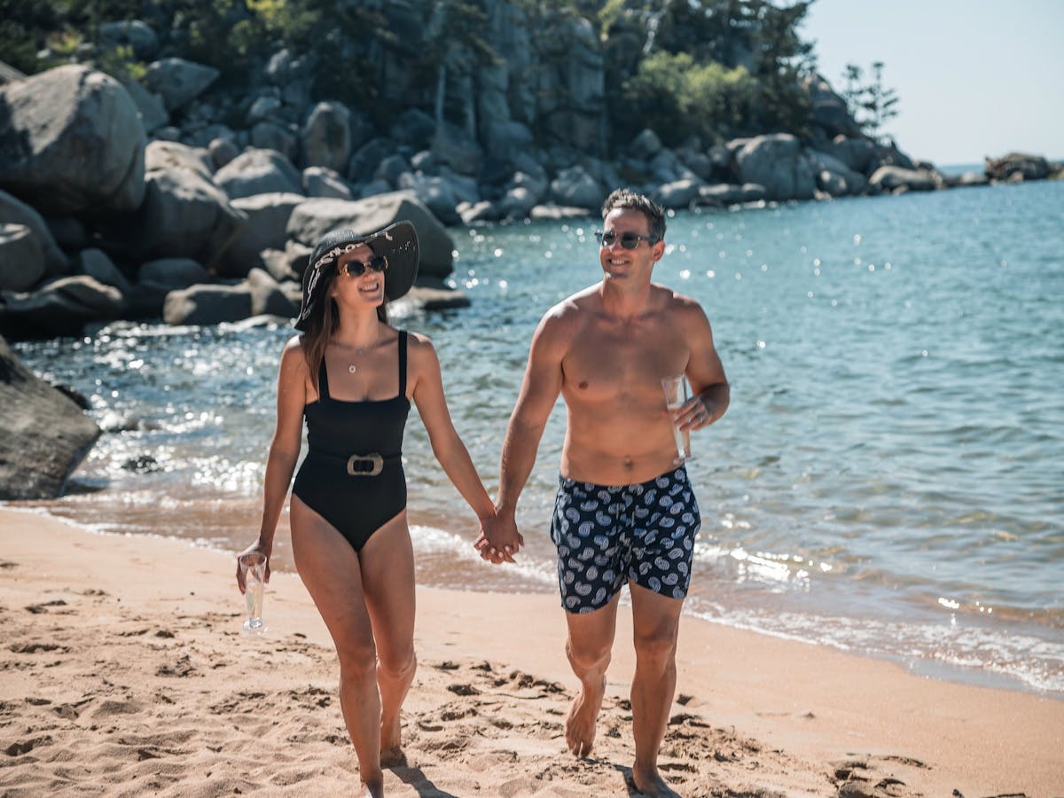 Couple walking along a remote beach