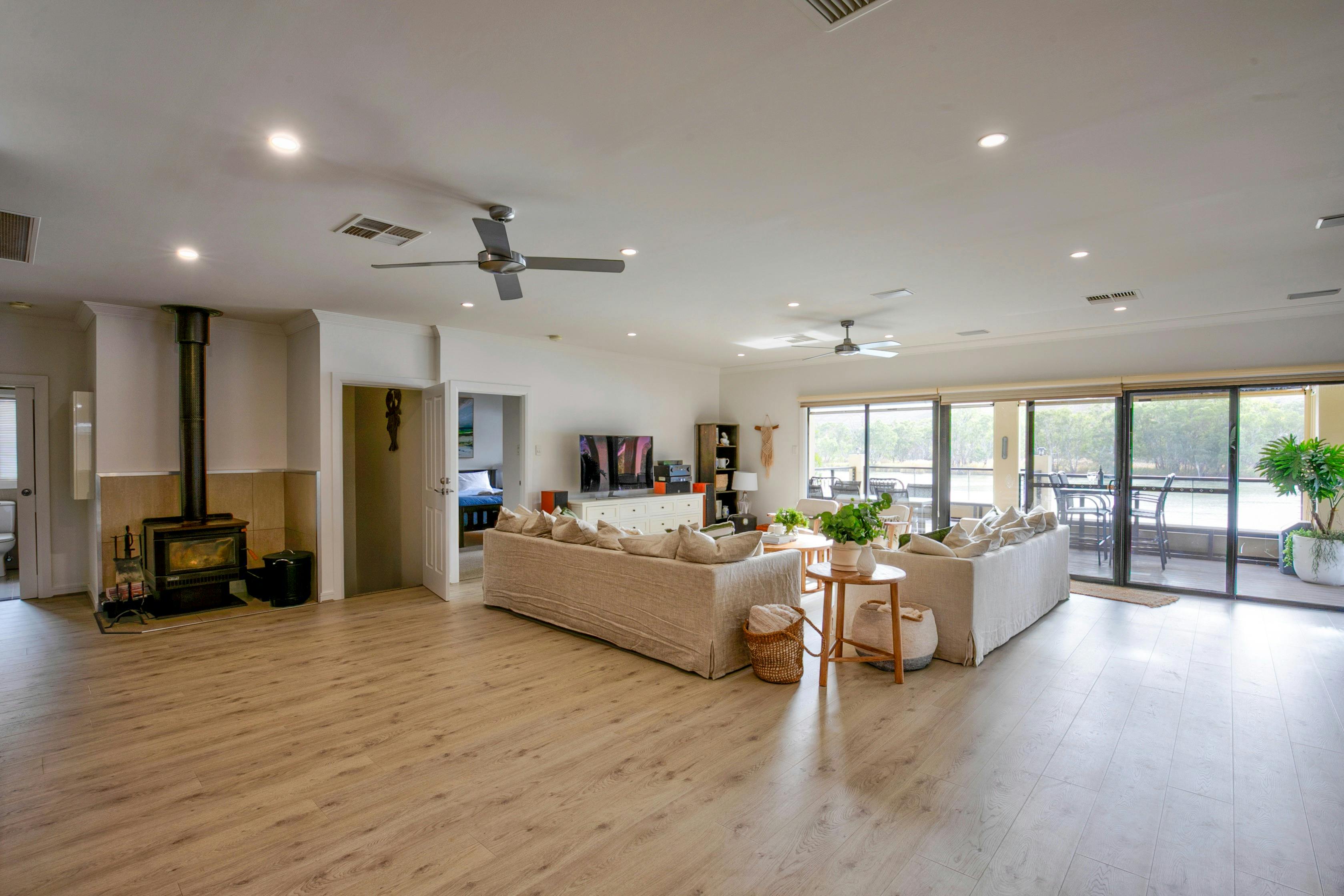 stunning open plan living, large lounge with combustion heater and stunning views