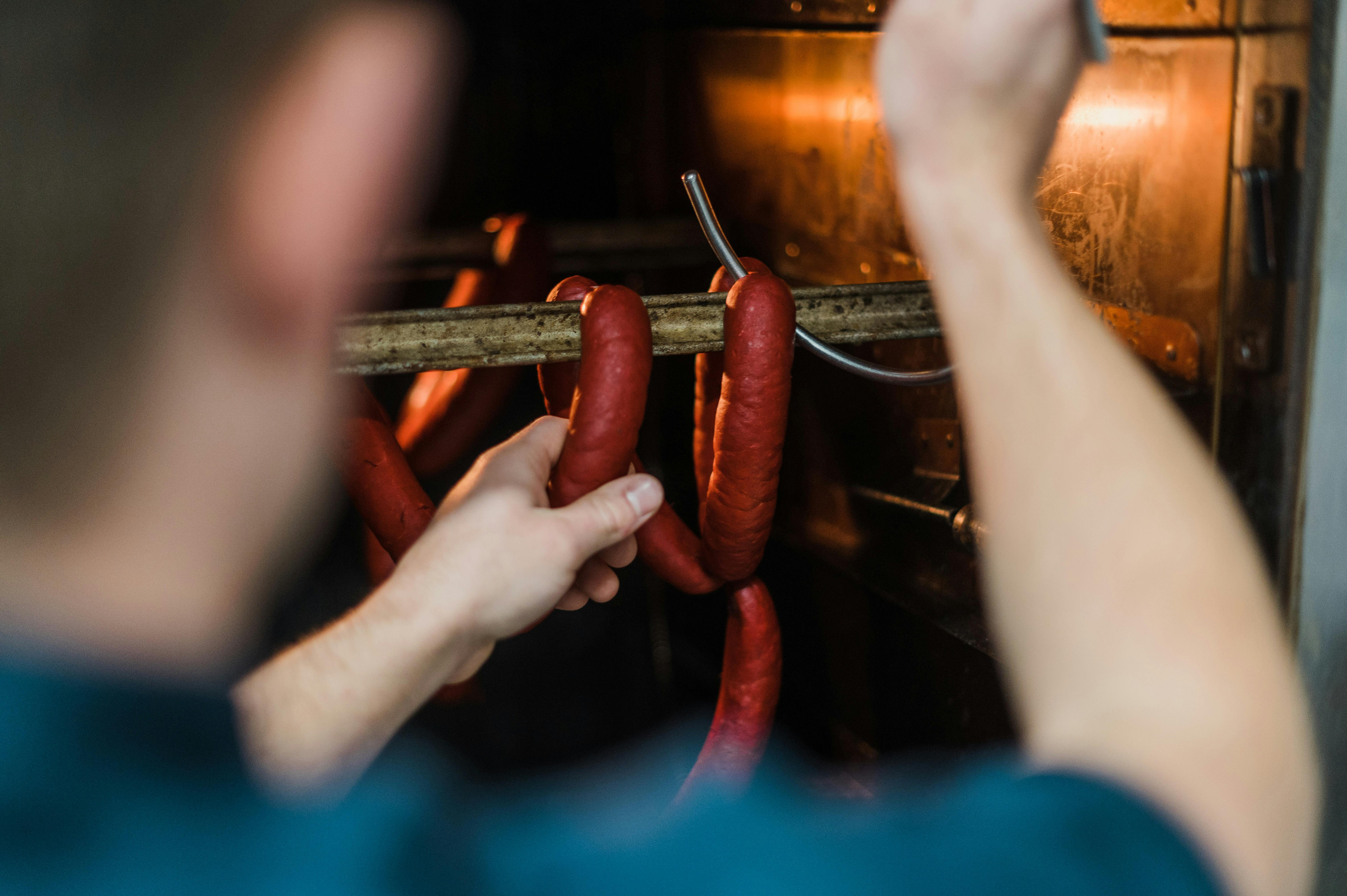 Image shows our staff loading product into our onsite smoke oven