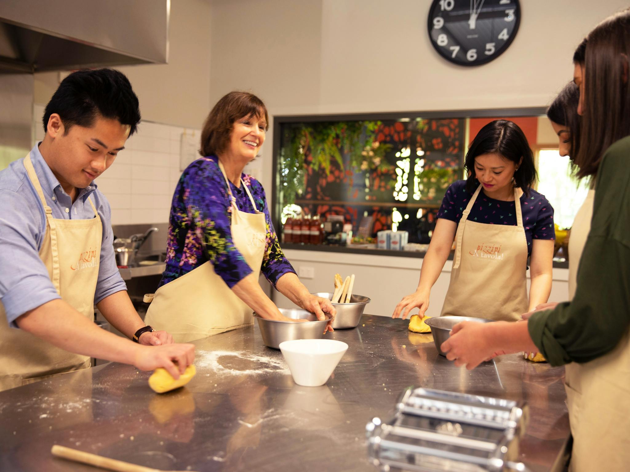 Katrina and guests in Pizzini cooking school kitchen