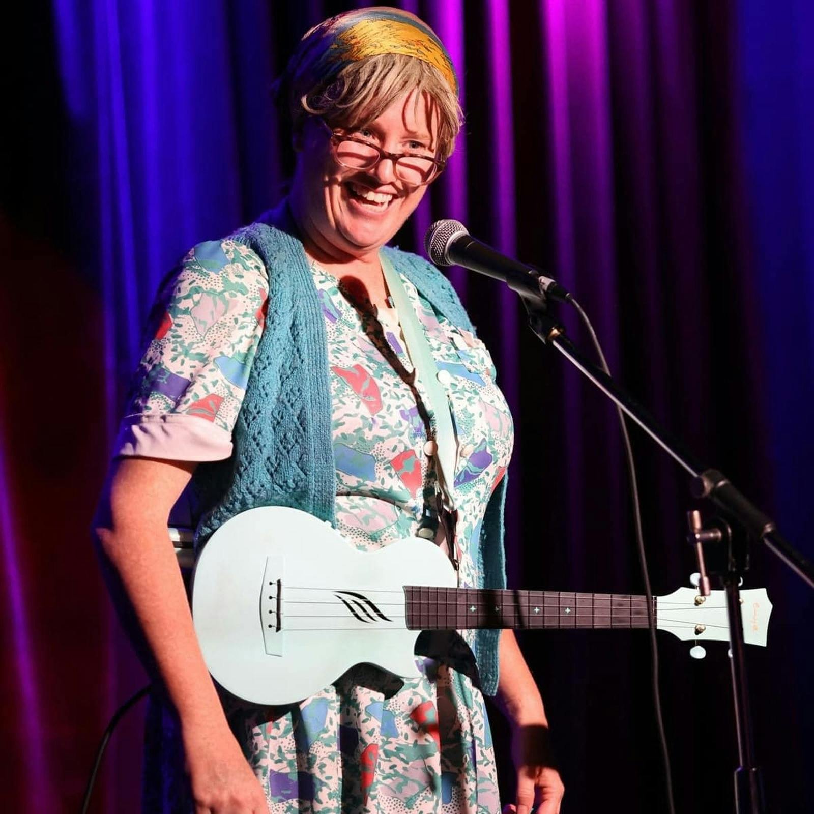 Lori Bell dressed in character as Granny Flaps with a ukulele