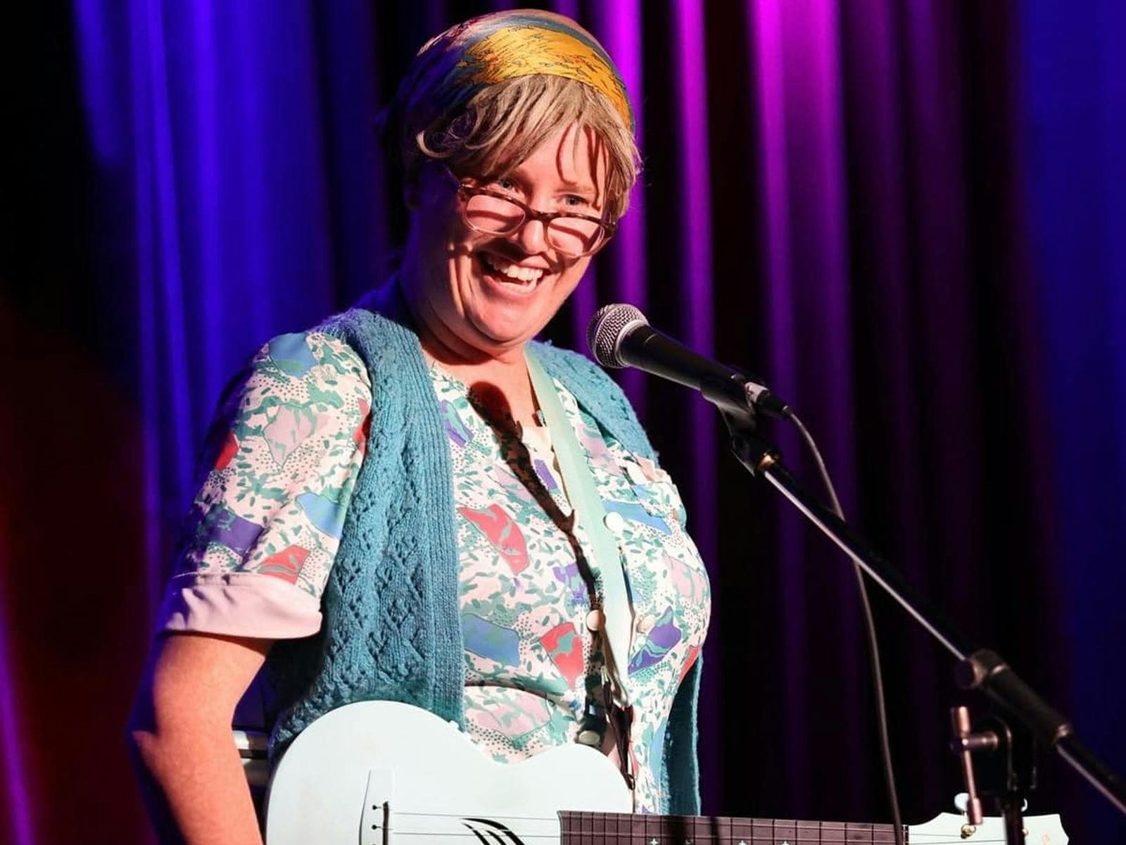 Lori Bell dressed in character as Granny Flaps with a ukulele