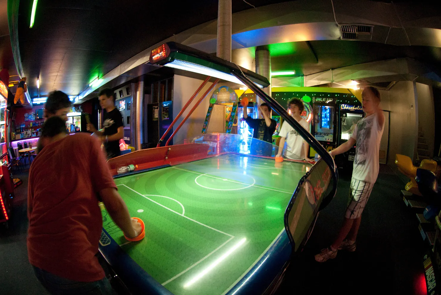 Group of teenagers cheering while playing air hockey at Laserzone Sunshine Coast