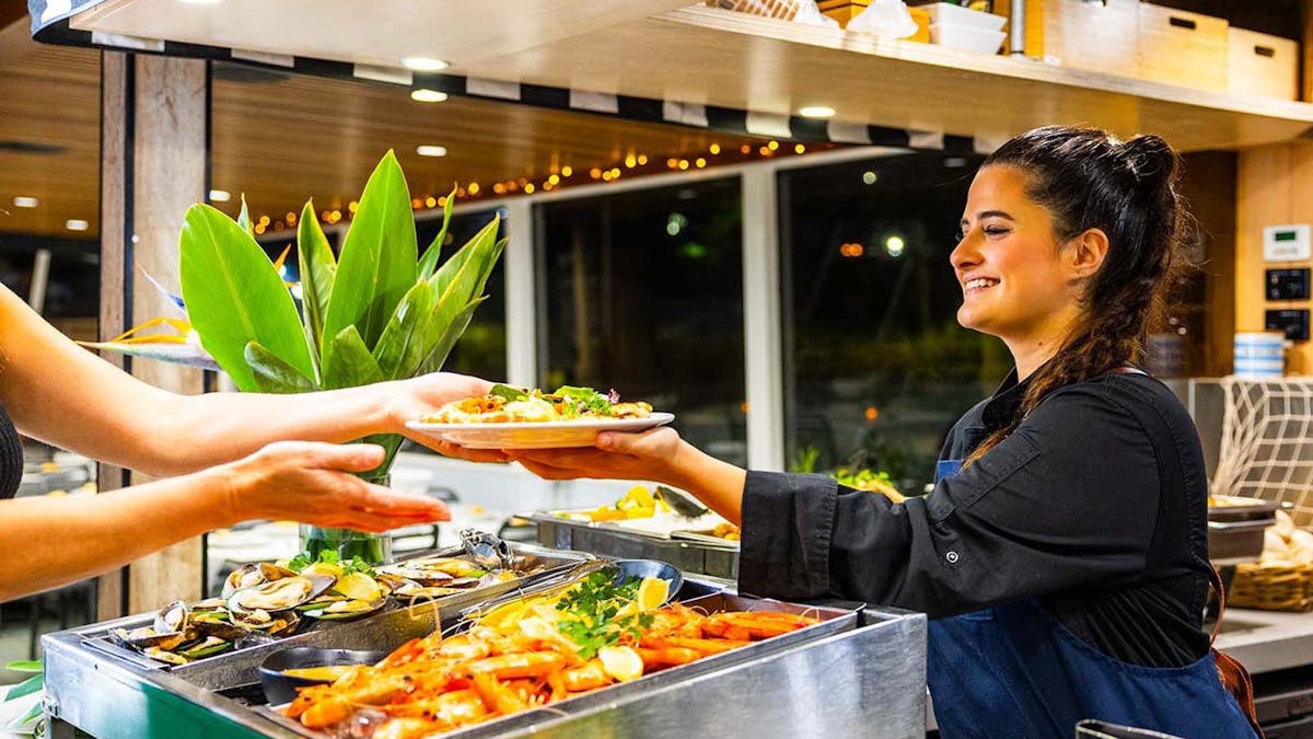 Friendly crew serving Buffet Dinner