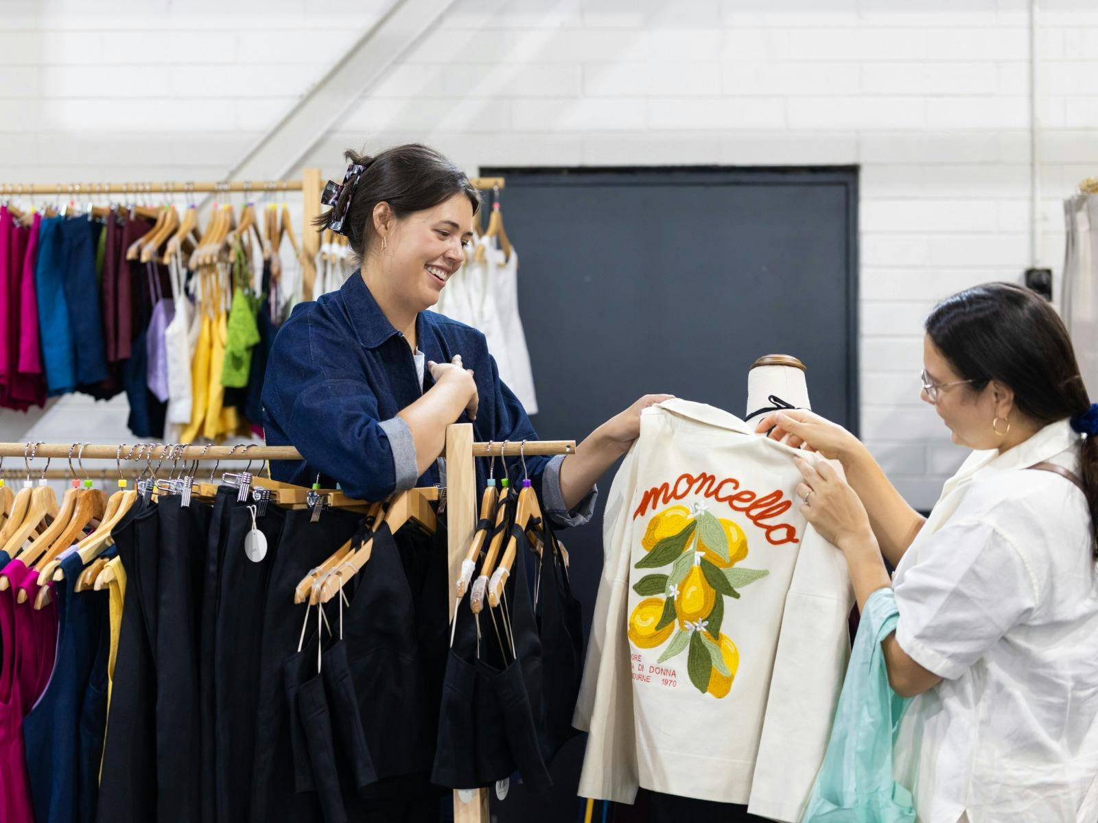 Al Elé showing a customer a jacket