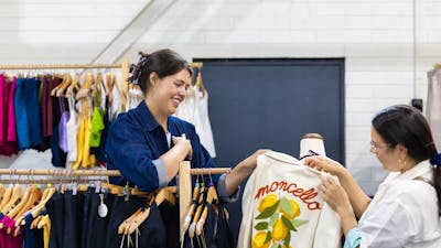 Al Elé showing a customer a jacket
