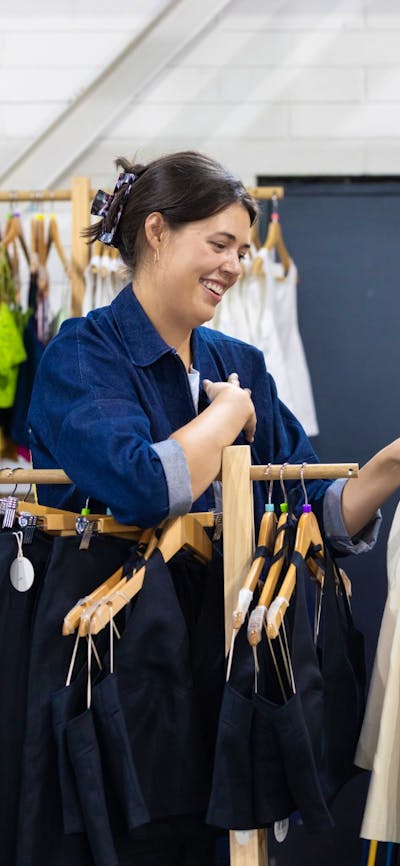 Al Elé showing a customer a jacket