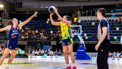 UC Capitals player shooting the basketball while a defender closes in.