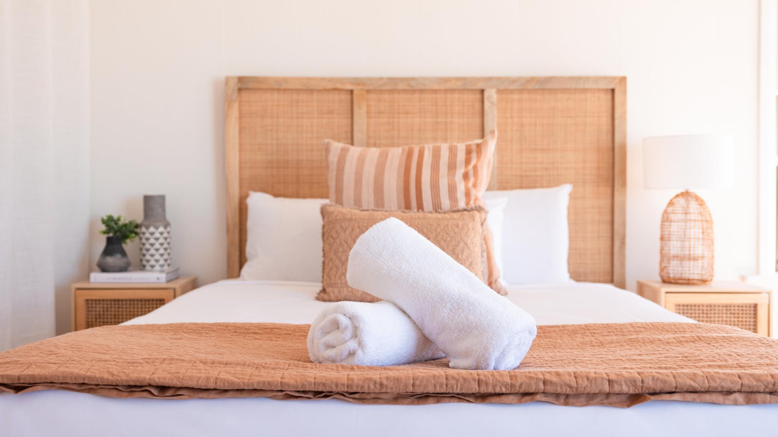 Cozy bedroom with fresh linens and soft, earthy tones for a restful night’s sleep.