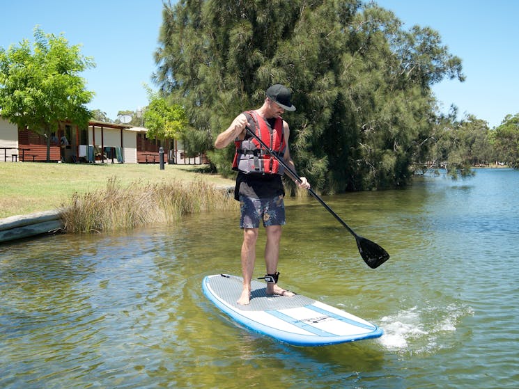 Guest on stand up paddle board