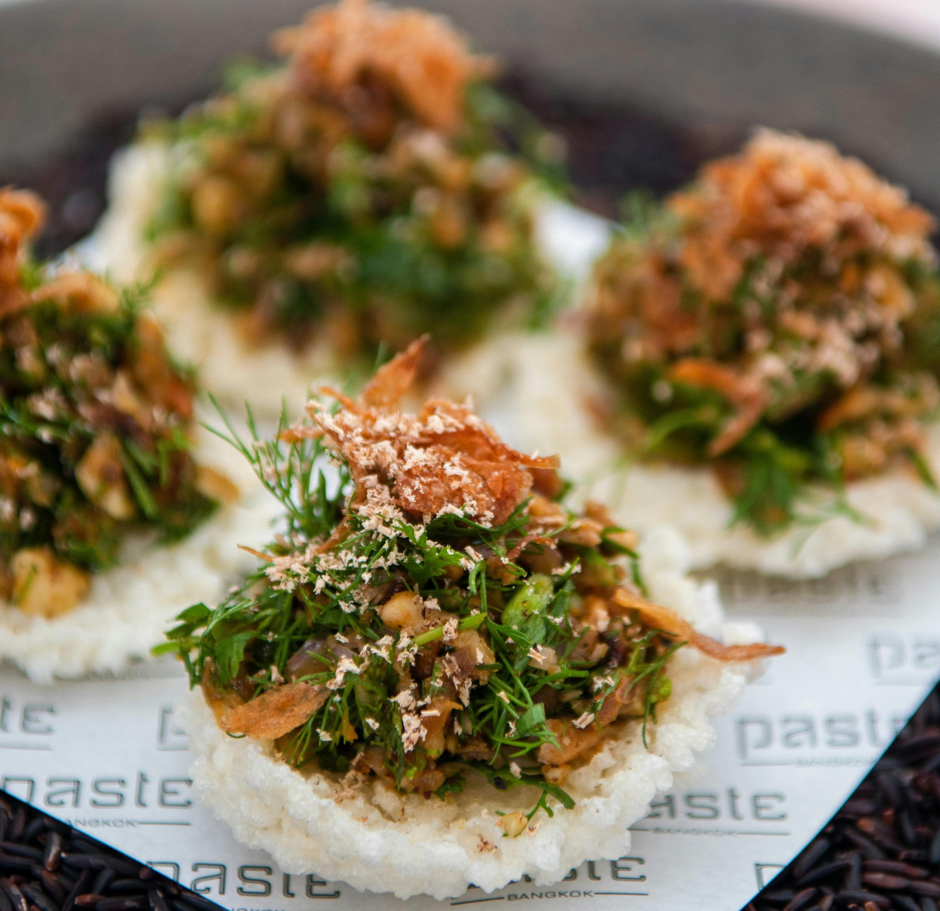 Starters. Roasted duck, nutmeg, curry paste & sawtooth coriander served on rice crackers