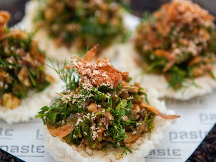 Starters. Roasted duck, nutmeg, curry paste & sawtooth coriander served on rice crackers