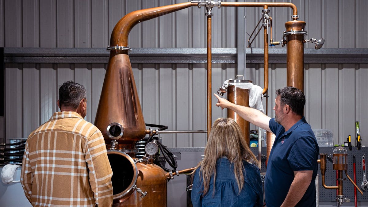 People looking at gin still