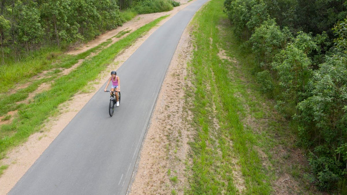 A woman riding along part of the Caboolture to Wamuran Rail Trail
