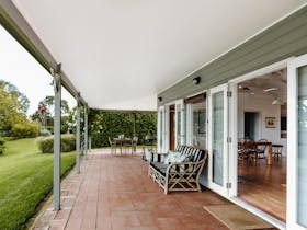 Cottage veranda with couch and view to gardens