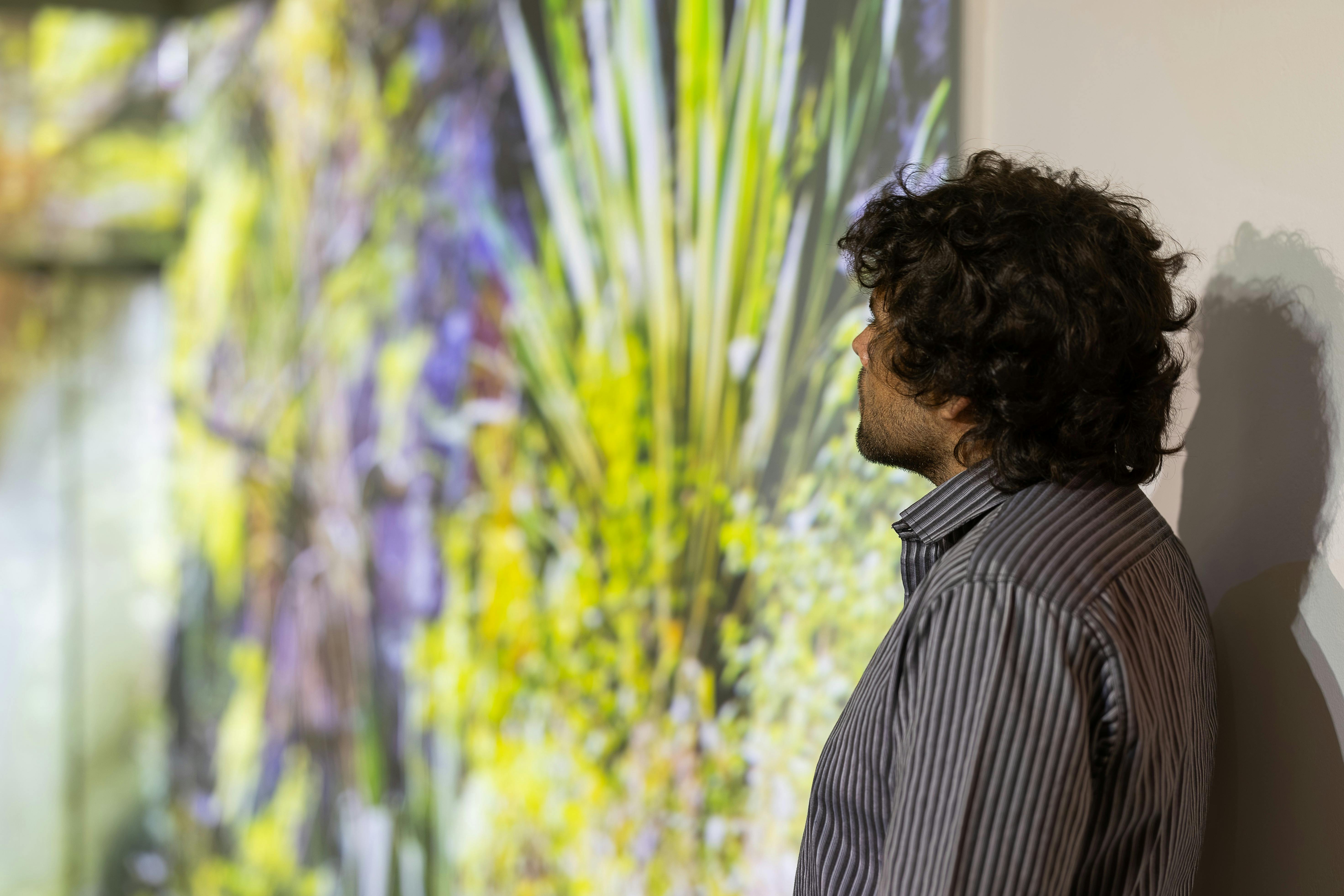 Man looking at wall projection