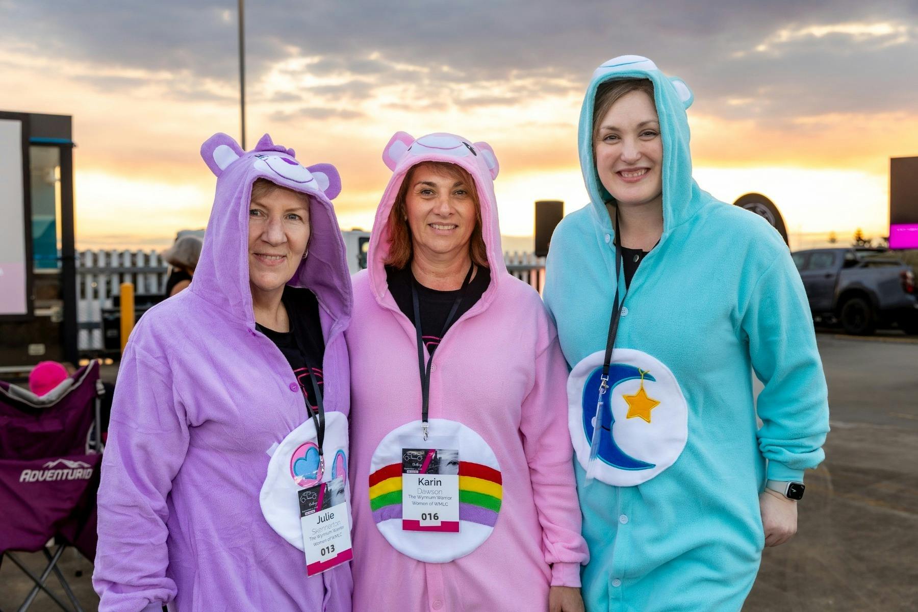 Three Gold Coast Live Like Her Challenge participants wearing colourful onesies and smiling