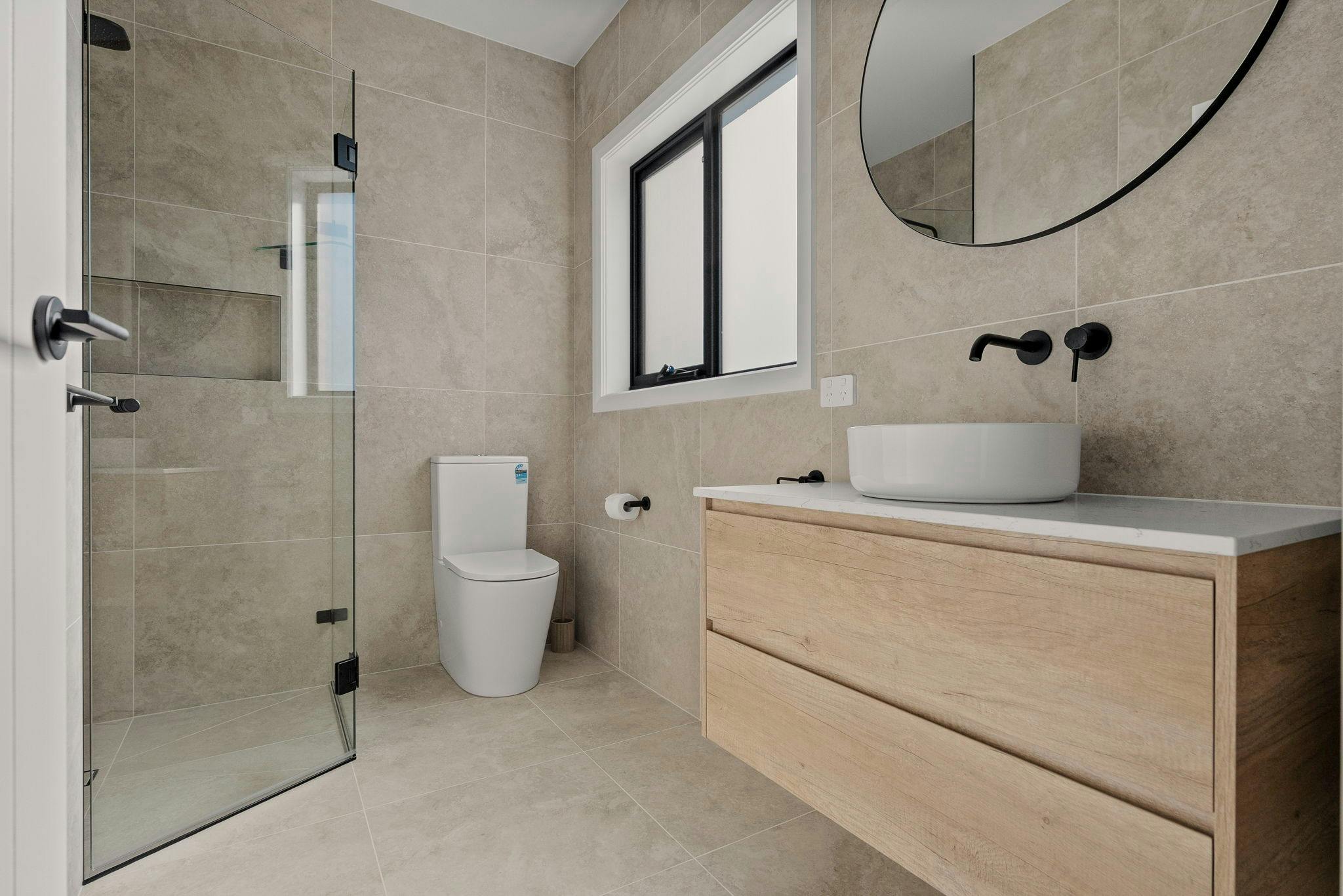 Ensuite with shower, vanity and toilet.