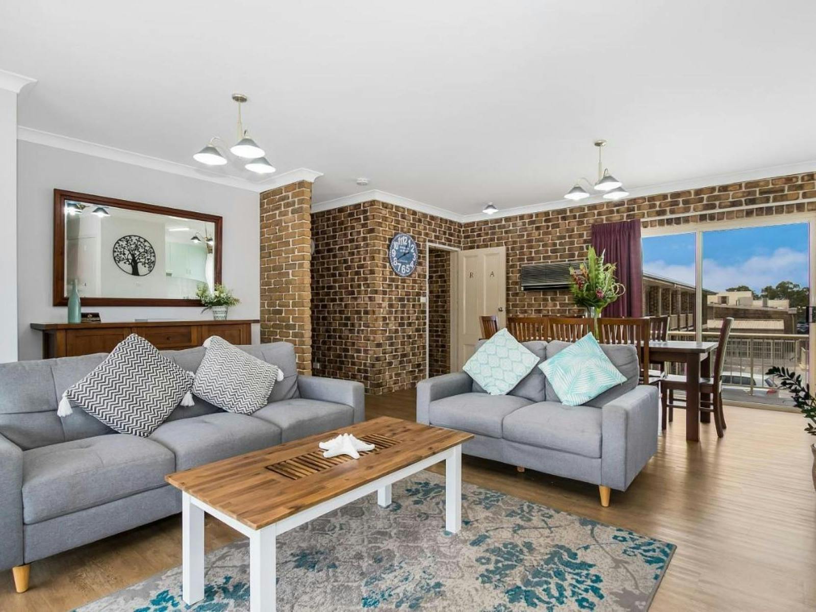 beautiful lounge room with timber coffee table and large windows