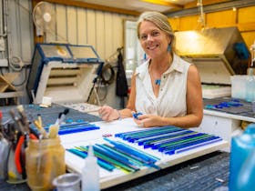 Cindy Poole Glass Artist in her creative design space . Step into the maker artist role  in a tour.