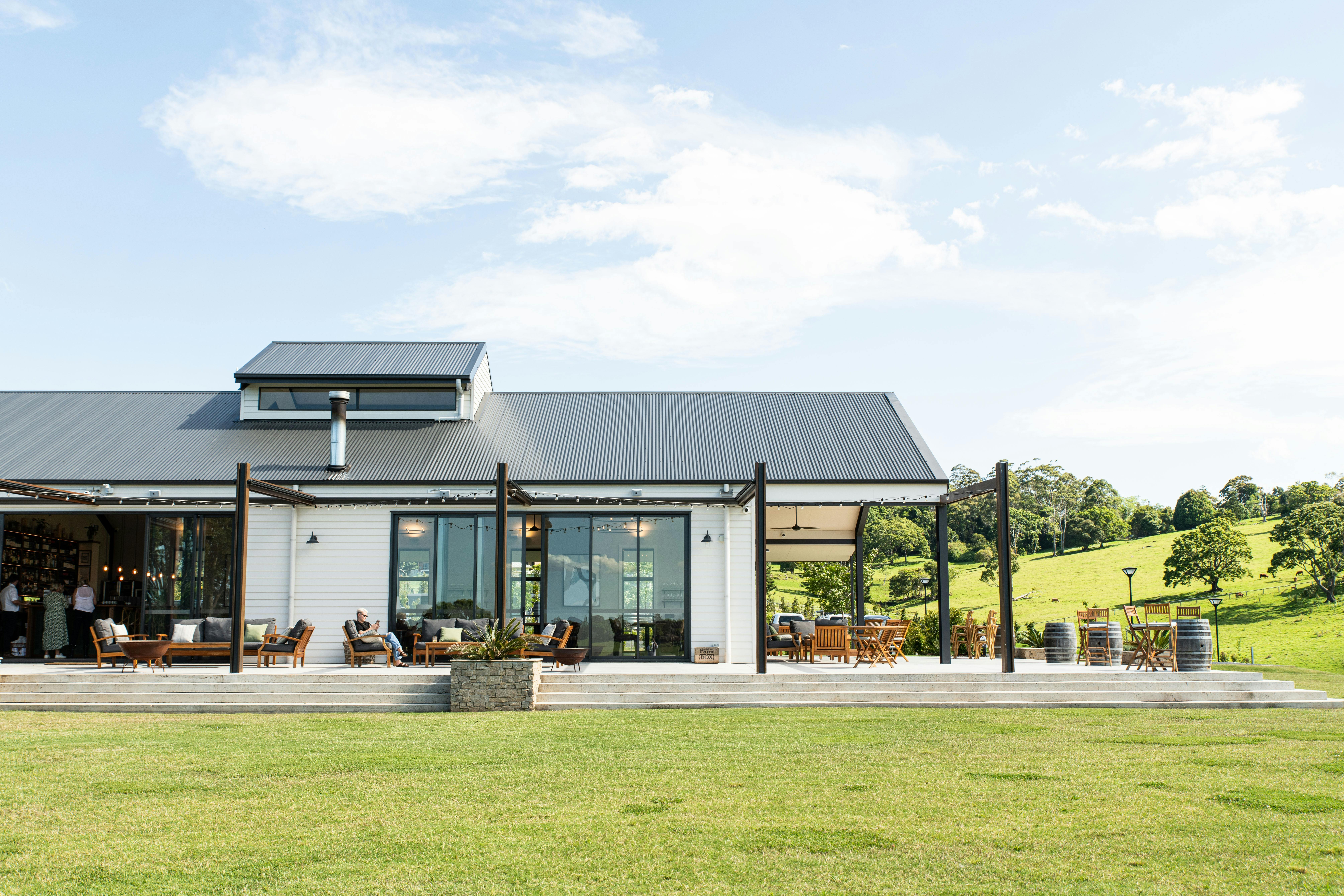 Image showing exterior of a restaurant with a terrace and green lawns with rolling hills