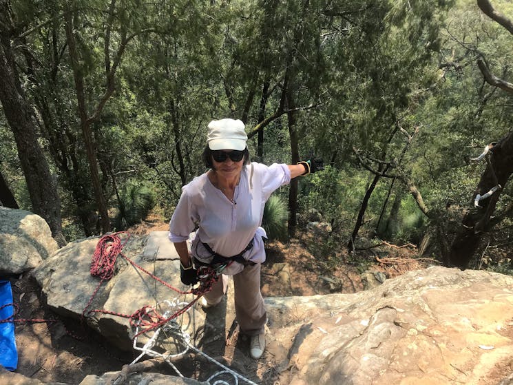 A person is wearing their harness , on top of the cliff on the Hunter Valley Abseiling Adventure