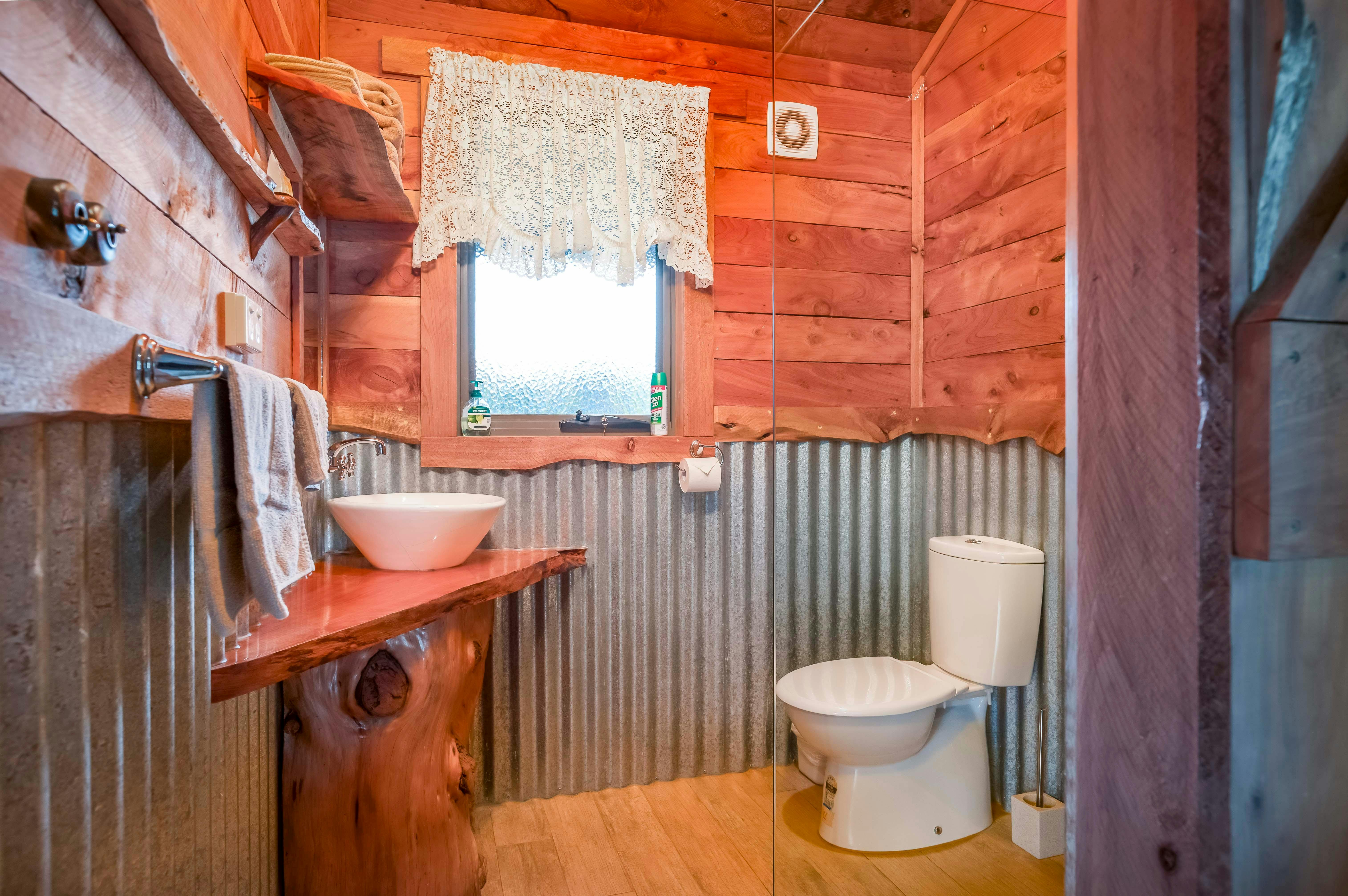 Country Hut bathroom, with shower hand basin ad toilet. No step into shower