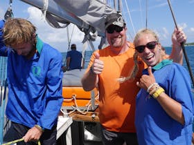 Crew and guest after hoisting sail on Ocean free, Great barrier Reef fun and adventure