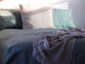 comfortable queen size bed with lots of pillows and cushions