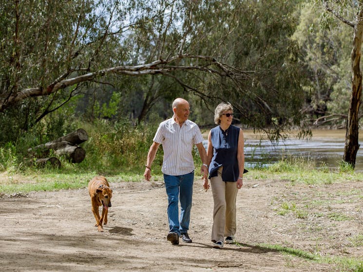 Couple walking along Murrumbidgee River