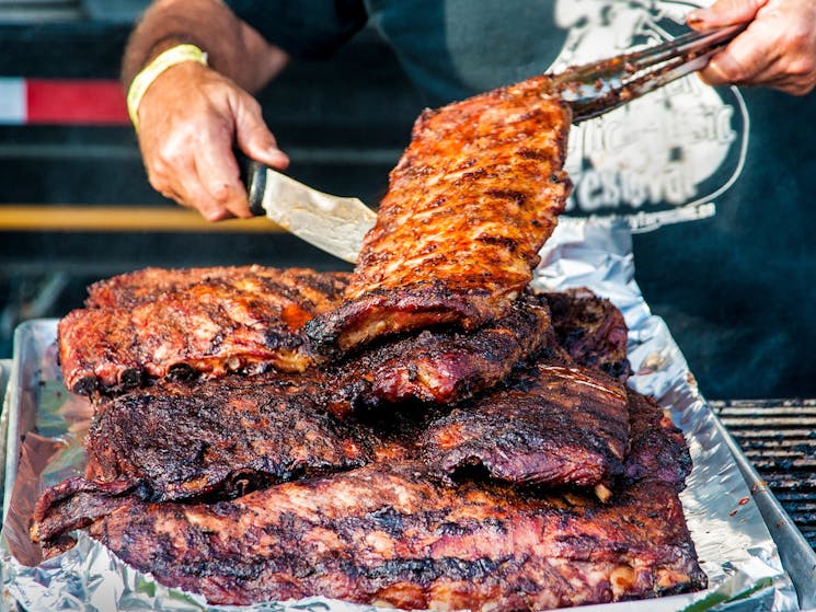 Competitor serving pork ribs