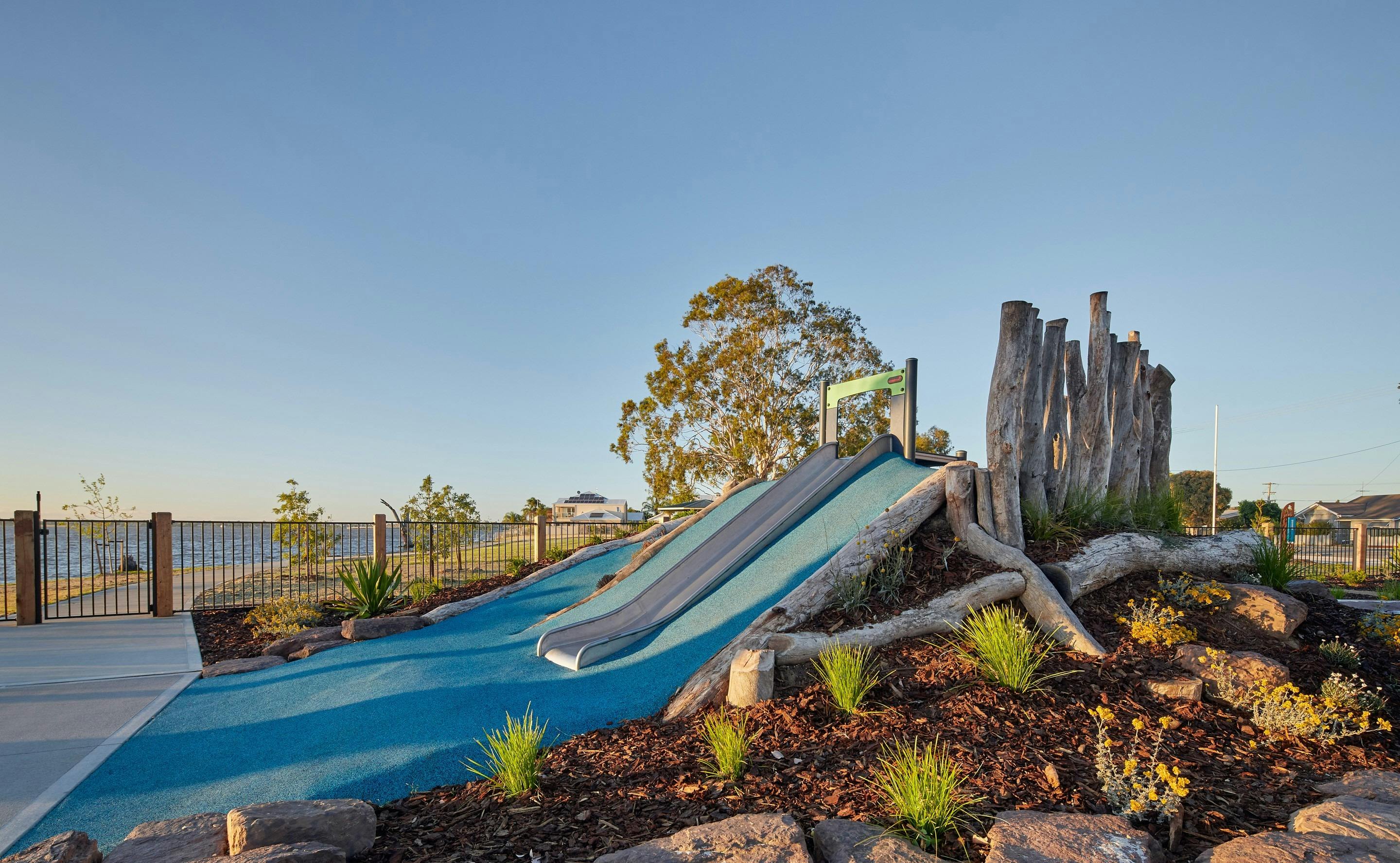 A blue slide surrounded by blue soft-fall rubber at Purtle Park.