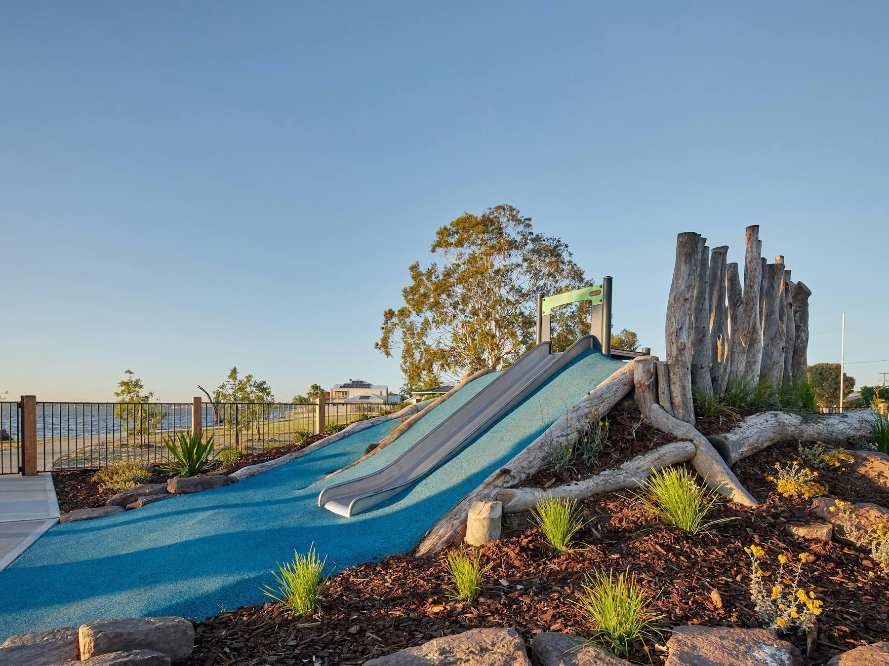 A blue slide surrounded by blue soft-fall rubber at Purtle Park.