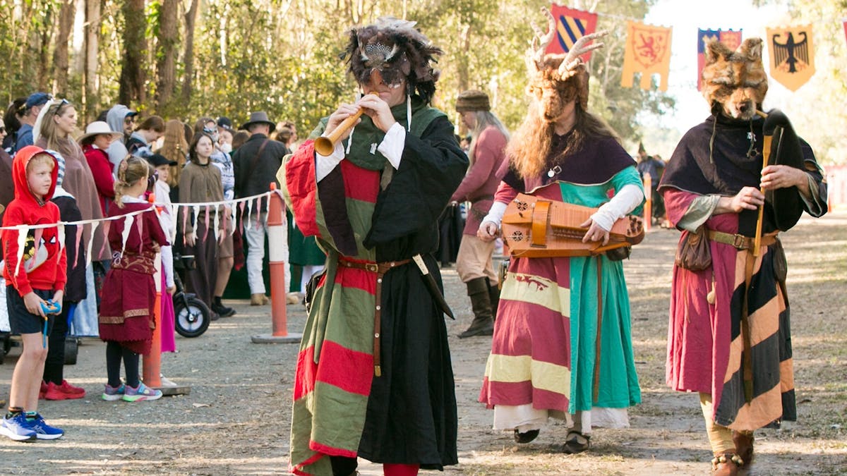 Musicians play along the entry to the Festival