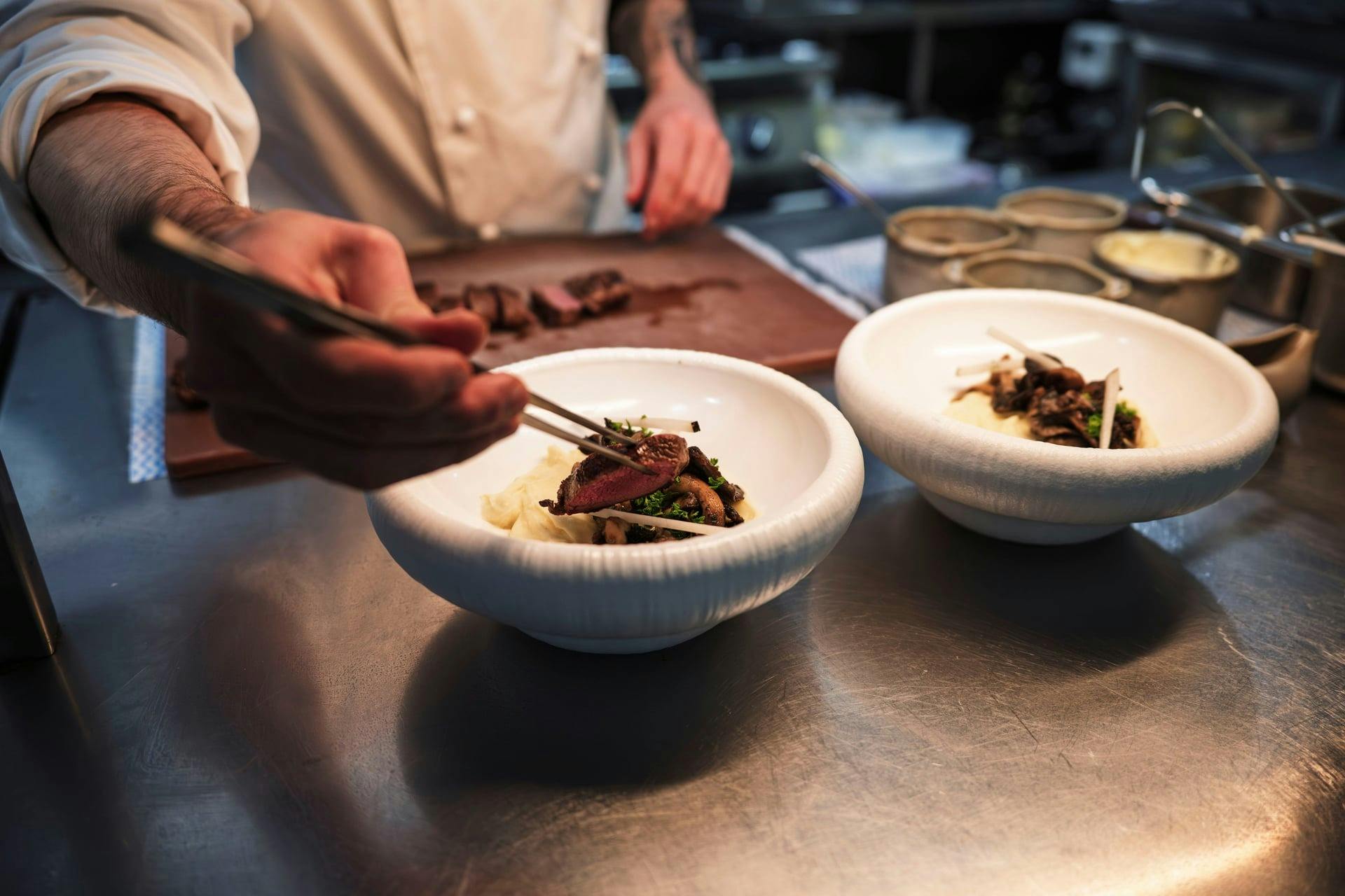 Chef plating food at Charlotte's Restaurant