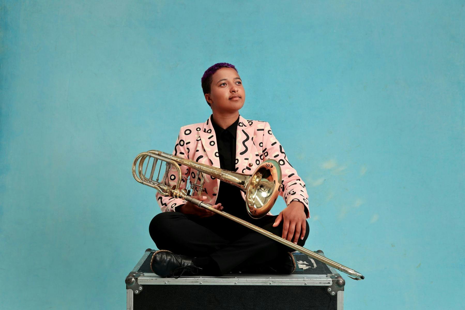 Trombonist sitting on a box