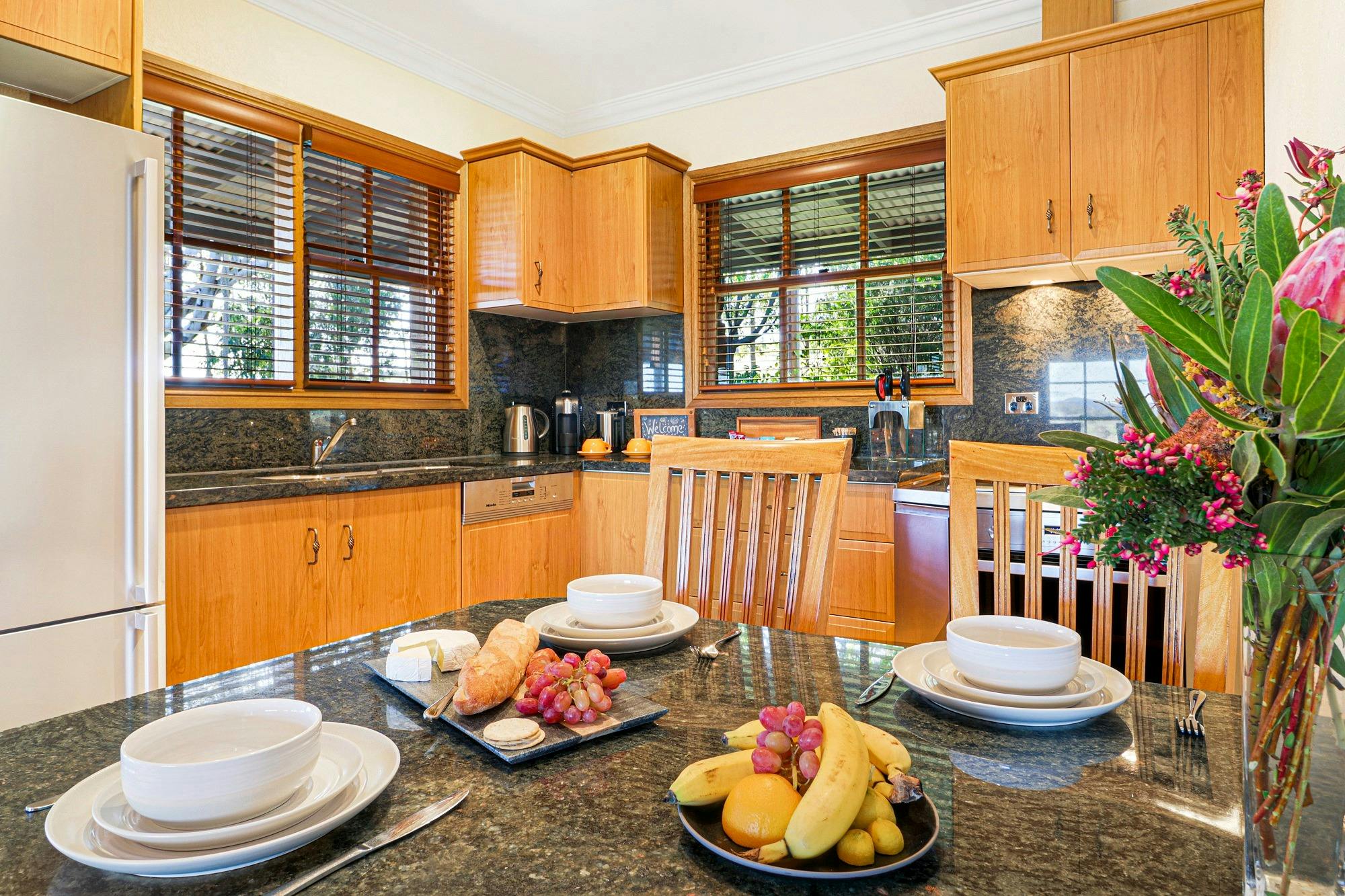 Full kitchen with full sized fridge, large sink, 4 burner stove and oven
