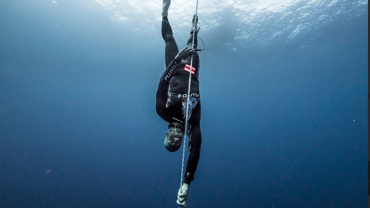 Australian Freediver Adam Sellars freediving without fins, pulling himself down the line